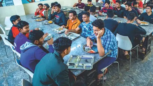 Students sharing a meal at the canteen tables.