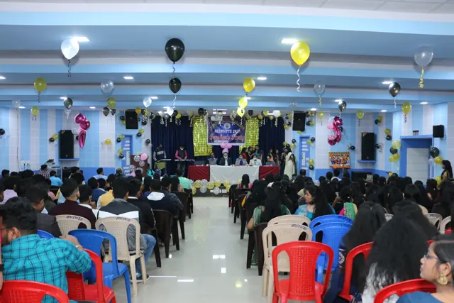 Students seated in the auditorium during a college event.