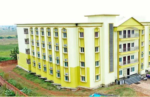 The multi-storey yellow hostel building on campus.
