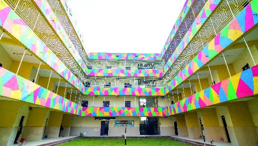 The hostel courtyard, ringed by balconies painted in bright geometric colours.