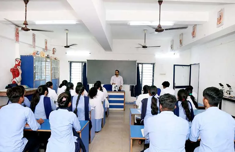 Students in lab coats seated in the zoology laboratory.