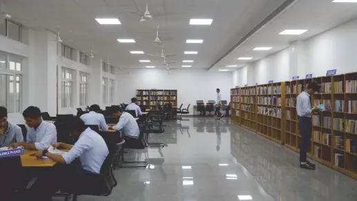 The air-conditioned library, with reading tables and tall bookshelves.